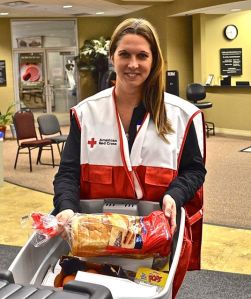 American Red Cross Volunteer Shannon Roberts packs a box of food to assist families affected by the recent tornadoes that tore through the Washington community destroying hundreds of homes. Photo Credit: Robert W. Wallace/American Red Cross 